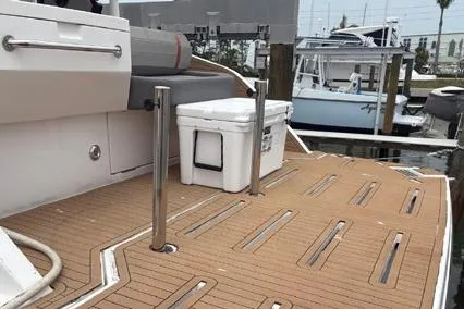  Yacht Photos Pics 2023 Hanover 377 boat deck with cooler, docked at marina.