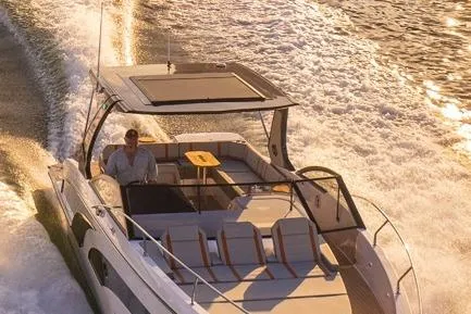  Yacht Photos Pics Luxurious 2023 Hanover 377 boat cruising on water at sunset.