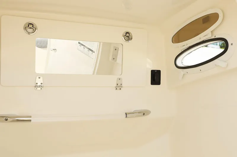 Joe Yacht Photos Pics Manufacturer Provided Image: 2018 Cobia 301 Center Console interior cabin with porthole and storage compartment.