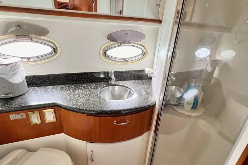  Yacht Photos Pics 2003 Carver 444 Cockpit Motor Yacht bathroom with sink, granite countertop, and porthole windows.