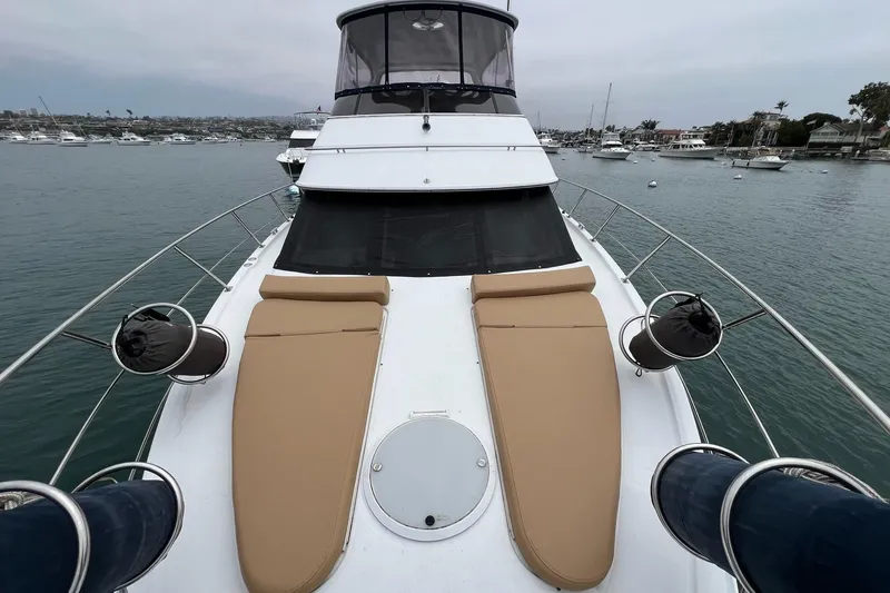  Yacht Photos Pics 2003 Carver 444 Cockpit Motor Yacht with tan sunbeds on deck, docked in a marina.