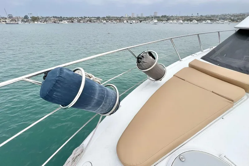  Yacht Photos Pics 2003 Carver 444 Cockpit Motor Yacht deck with fenders and tan cushions, overlooking marina.