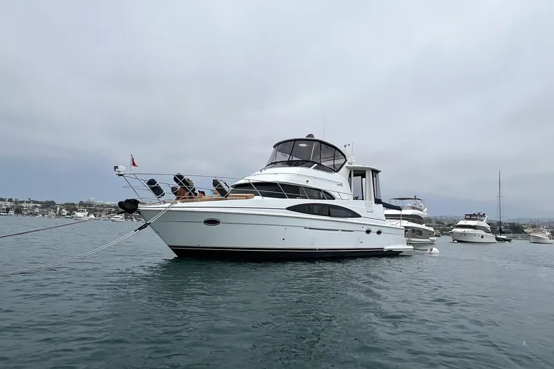 Yacht Photos Pics 2003 Carver 444 Cockpit Motor Yacht anchored in a marina, overcast sky.