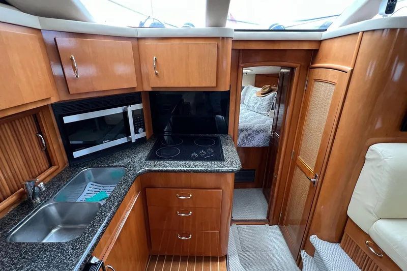  Yacht Photos Pics Interior of 2003 Carver 444 Cockpit Motor Yacht with kitchen and bedroom view.