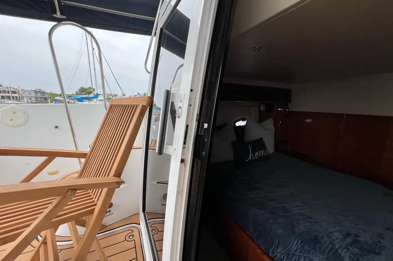  Yacht Photos Pics 2003 Carver 444 Cockpit Motor Yacht interior with wooden chair and cozy bedroom.