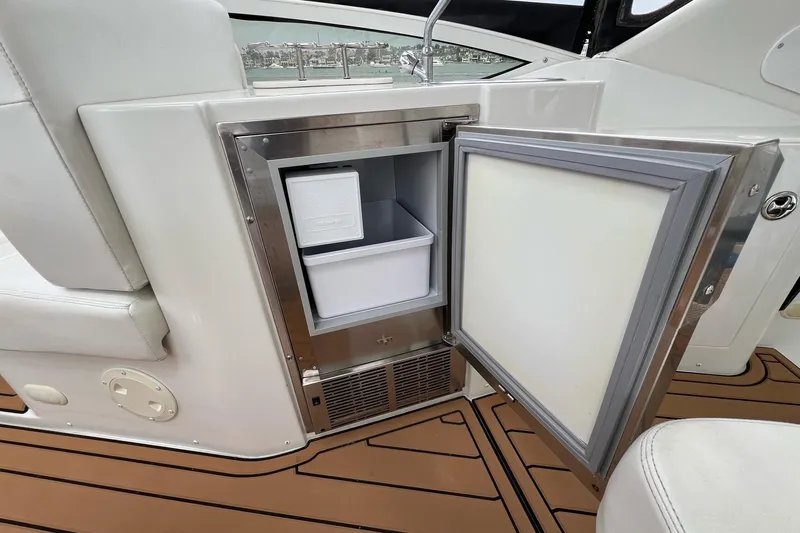  Yacht Photos Pics Open mini fridge on 2003 Carver 444 Cockpit Motor Yacht, showcasing interior storage.