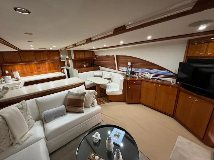  Yacht Photos Pics Luxurious interior of 2004 Bertram 510 Convertible yacht with elegant wood finishes and plush seating.
