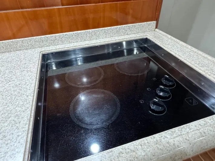  Yacht Photos Pics Stovetop in 2004 Bertram 510 Convertible yacht kitchen with granite countertop.