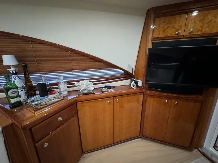  Yacht Photos Pics Luxurious interior of 2004 Bertram 510 Convertible yacht with wooden cabinets and modern TV.