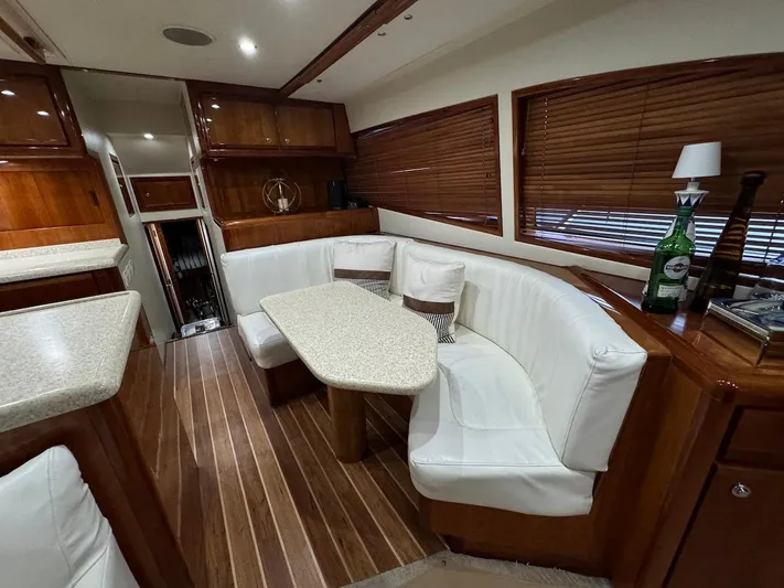  Yacht Photos Pics Luxurious interior of 2004 Bertram 510 Convertible yacht with elegant seating and wooden accents.