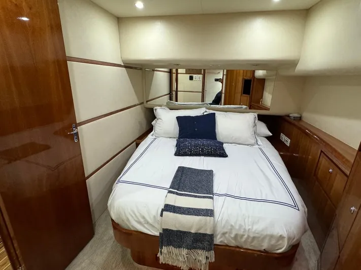  Yacht Photos Pics Luxurious bedroom interior of 2004 Bertram 510 Convertible yacht with cozy bedding.