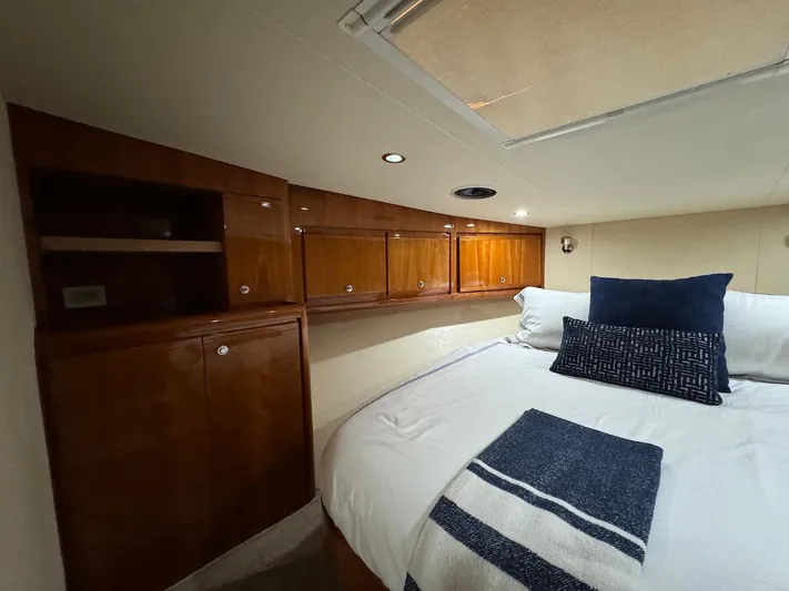  Yacht Photos Pics Luxurious cabin interior of 2004 Bertram 510 Convertible yacht with cozy bedding.