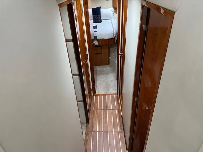  Yacht Photos Pics Interior hallway of 2004 Bertram 510 Convertible yacht with wood paneling.