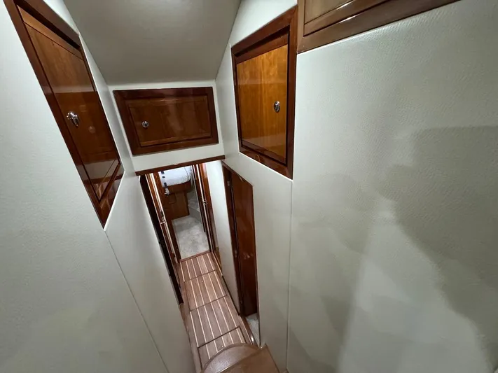  Yacht Photos Pics Interior hallway of 2004 Bertram 510 Convertible yacht with wooden cabinets.