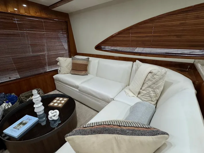  Yacht Photos Pics Luxurious interior of 2004 Bertram 510 Convertible yacht with white sofa and wooden accents.