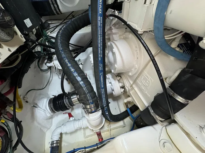  Yacht Photos Pics Engine room of 2004 Bertram 510 Convertible with visible hoses and machinery.