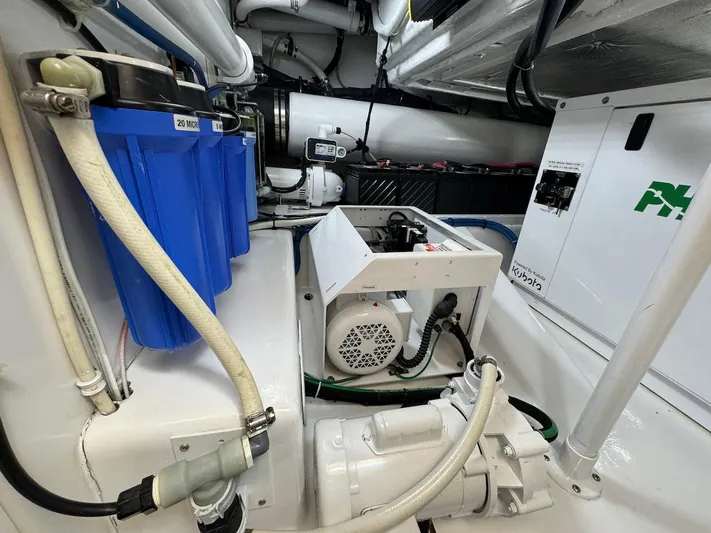  Yacht Photos Pics Engine room of 2004 Bertram 510 Convertible yacht, showcasing machinery and components.