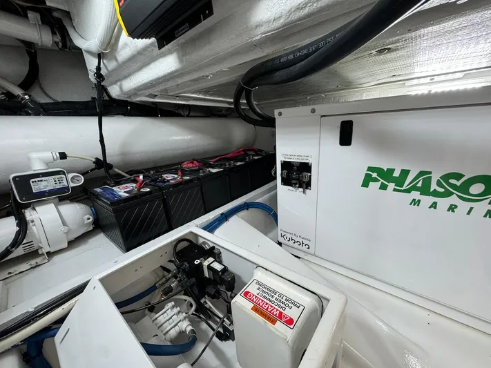  Yacht Photos Pics Engine room of 2004 Bertram 510 Convertible with Phasor Marine generator.