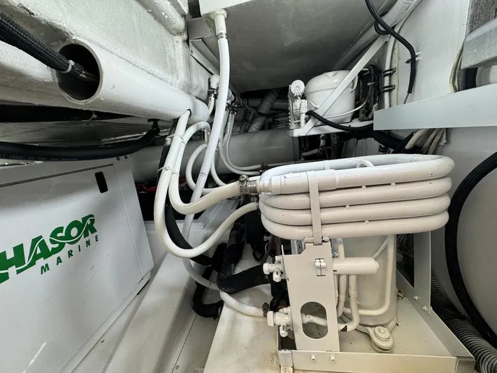  Yacht Photos Pics Engine room of 2004 Bertram 510 Convertible yacht with marine equipment and piping.