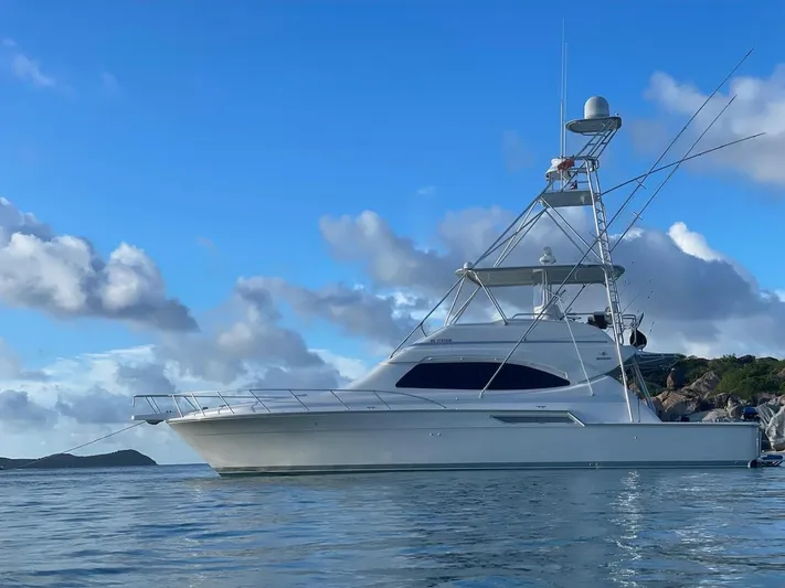  Yacht Photos Pics 2004 Bertram 510 Convertible yacht on calm water under blue sky.