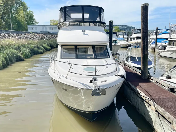  Yacht Photos Pics 2003 Meridian 341 Sedan yacht docked in a marina, front view.