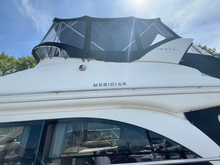  Yacht Photos Pics 2003 Meridian 341 Sedan yacht with sleek design and upper deck canopy.