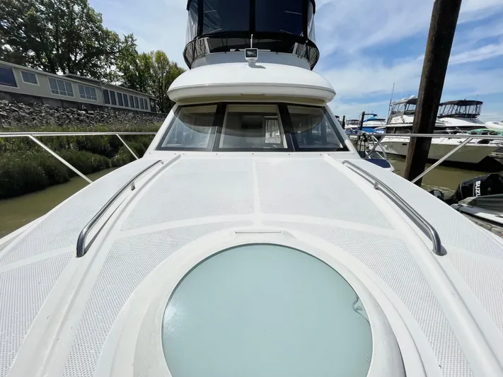  Yacht Photos Pics 2003 Meridian 341 Sedan yacht with sleek deck and circular hatch, docked at marina.