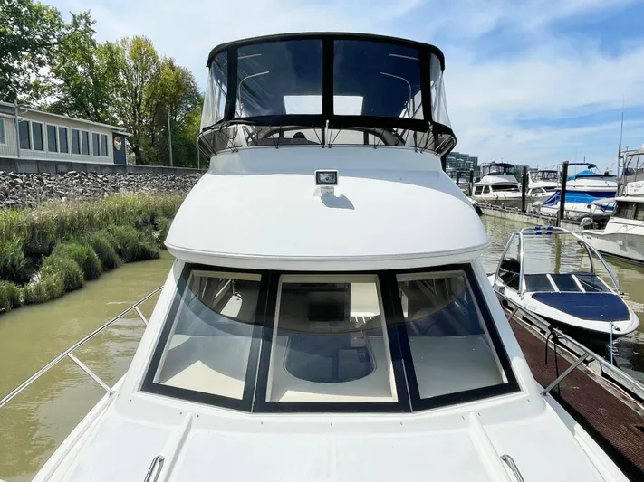  Yacht Photos Pics 2003 Meridian 341 Sedan yacht docked at a marina, showcasing sleek design and spacious cabin.