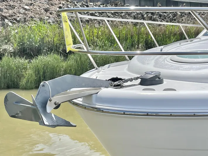  Yacht Photos Pics 2003 Meridian 341 Sedan boat with anchor, docked near lush greenery.