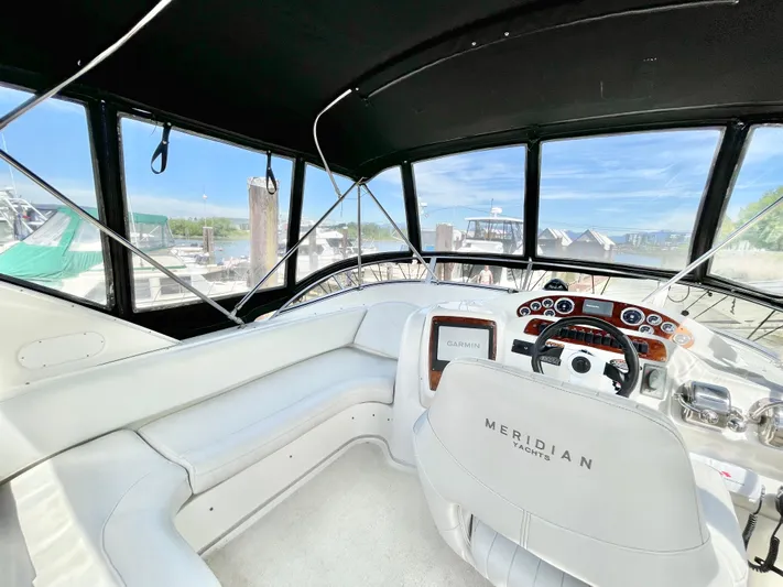 Yacht Photos Pics 2003 Meridian 341 Sedan yacht interior with helm, white seating, and panoramic windows.