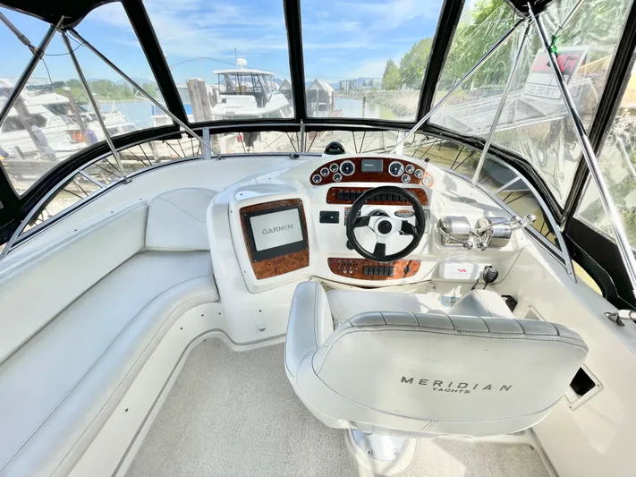  Yacht Photos Pics Cockpit of 2003 Meridian 341 Sedan with steering wheel and navigation system.