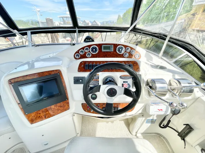  Yacht Photos Pics 2003 Meridian 341 Sedan helm with wood accents and modern navigation controls.
