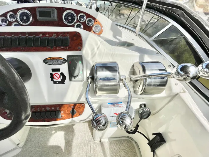  Yacht Photos Pics Control panel of a 2003 Meridian 341 Sedan boat with dual throttle levers.