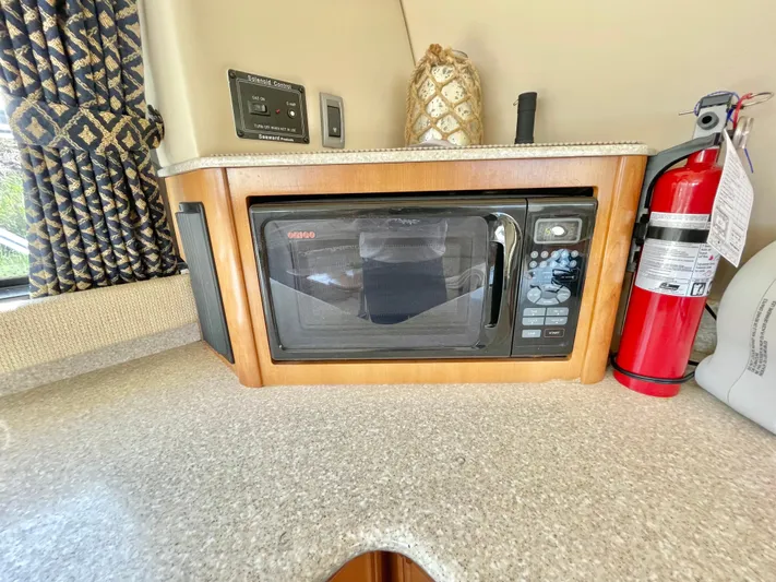  Yacht Photos Pics Microwave and fire extinguisher on 2003 Meridian 341 Sedan yacht kitchen counter.