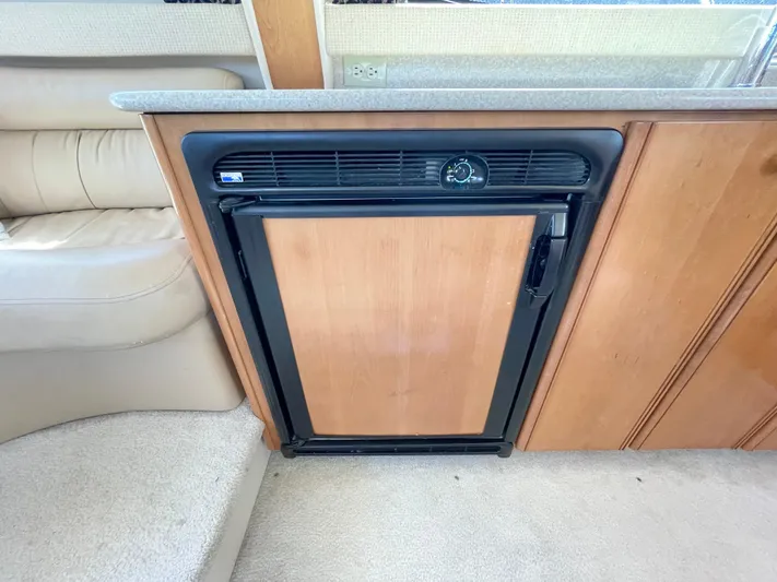  Yacht Photos Pics 2003 Meridian 341 Sedan interior with compact wooden refrigerator.