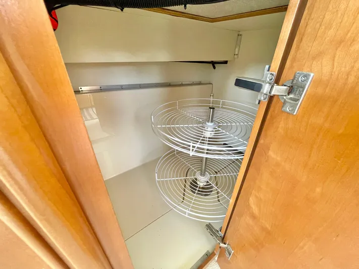  Yacht Photos Pics Open cabinet with wire shelving in a 2003 Meridian 341 Sedan.