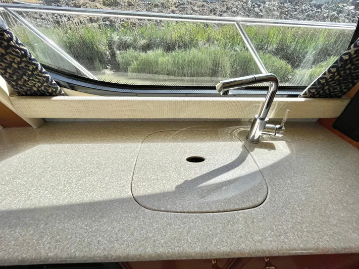  Yacht Photos Pics 2003 Meridian 341 Sedan yacht kitchen sink with countertop and window view.