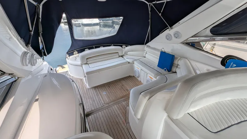 Cavallo Yacht Photos Pics Luxurious 2004 Sunseeker Portofino yacht interior with white seating and wooden flooring.