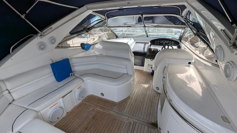 Cavallo Yacht Photos Pics Luxurious 2004 Sunseeker Portofino yacht interior with white seating and wooden flooring.