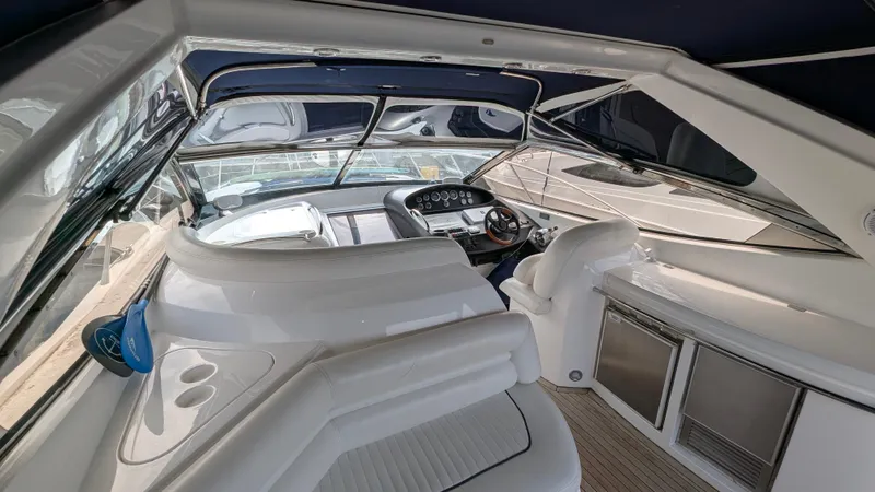 Cavallo Yacht Photos Pics 2004 Sunseeker Portofino yacht interior with sleek white seating and modern dashboard.