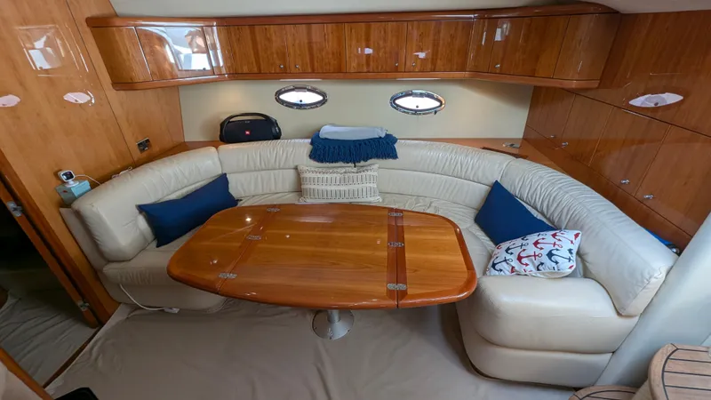 Cavallo Yacht Photos Pics Luxurious 2004 Sunseeker Portofino yacht interior with elegant seating and wooden table.