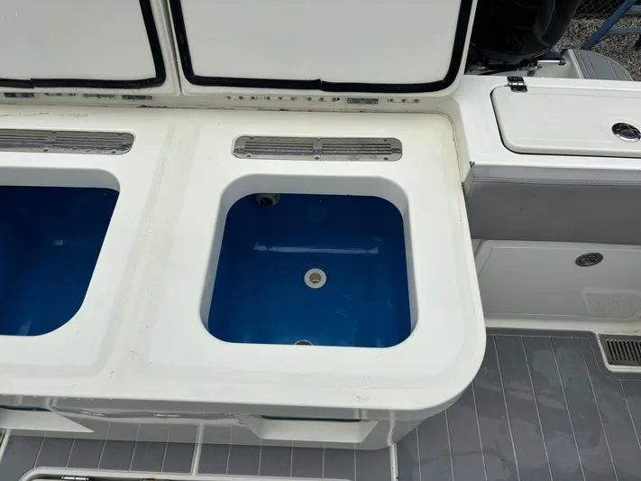  Yacht Photos Pics 2017 HCB Speciale boat livewell compartments, open and empty, with blue interior.