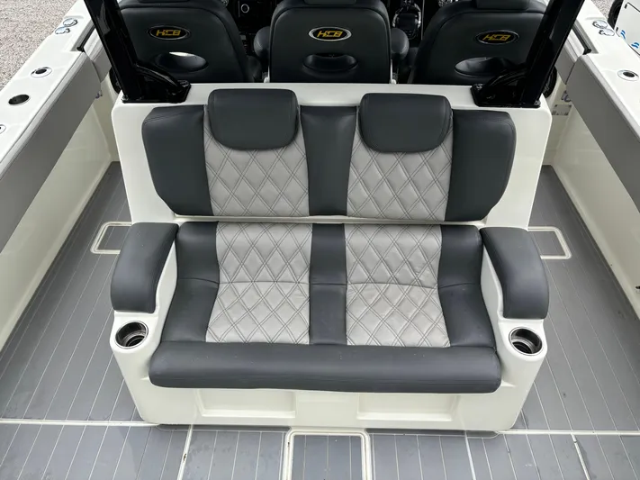  Yacht Photos Pics 2017 HCB Speciale boat seating with gray and black upholstery, featuring cup holders.