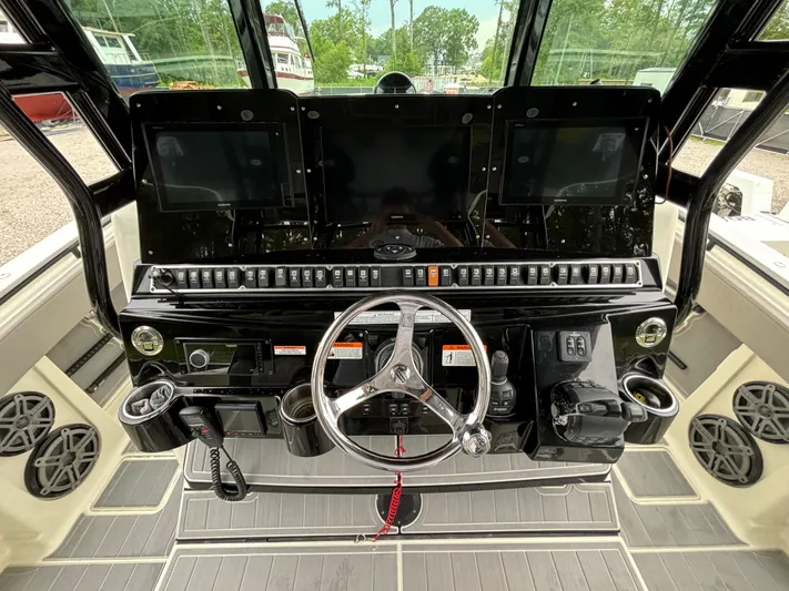  Yacht Photos Pics 2017 HCB Speciale boat dashboard with steering wheel and electronic controls.