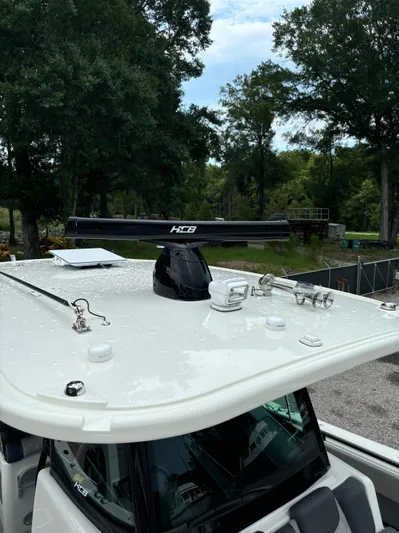  Yacht Photos Pics 2017 HCB Speciale boat roof with radar and antennas, surrounded by trees.