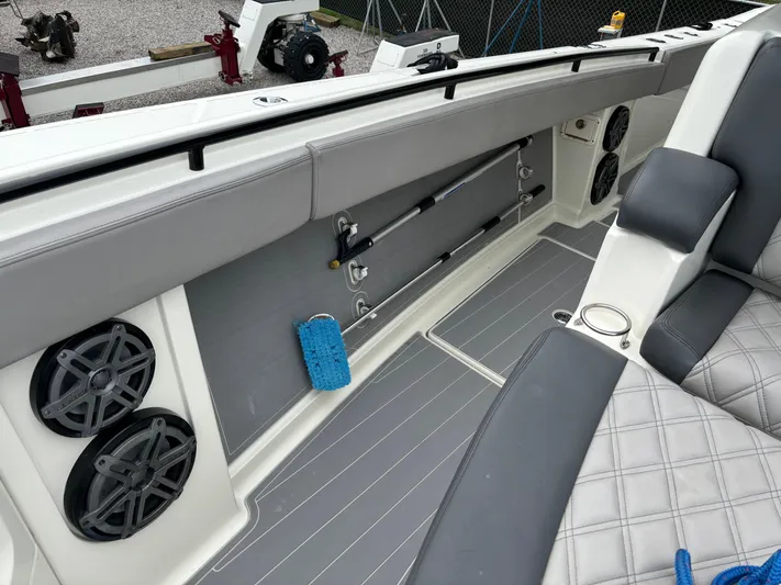  Yacht Photos Pics 2017 HCB Speciale boat interior with gray seating, speakers, and fishing rod holders.