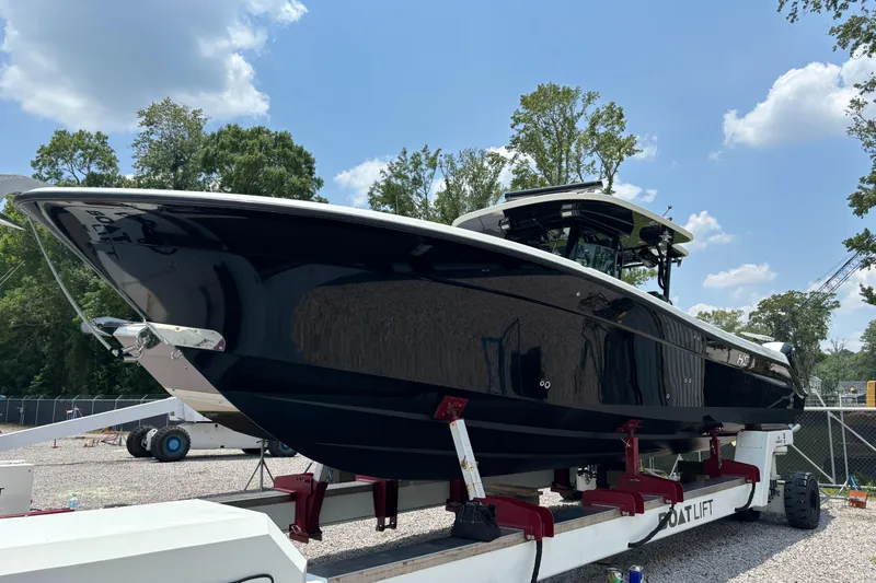  Yacht Photos Pics 2017 HCB Speciale boat on a lift, surrounded by trees and blue sky.