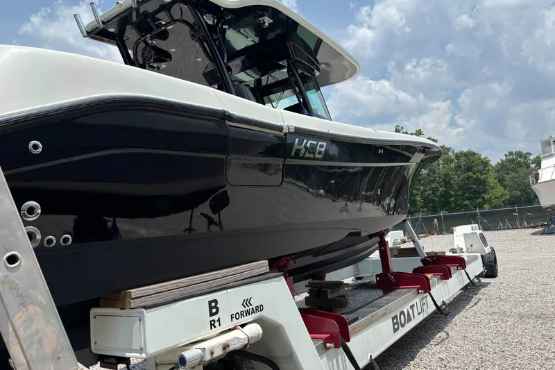 Yacht Photos Pics 2017 HCB Speciale boat on a lift, outdoors under a cloudy sky.