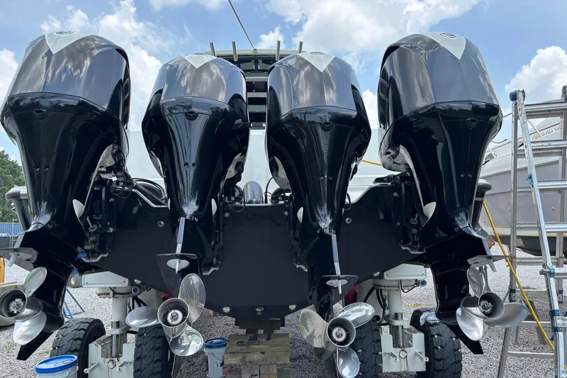  Yacht Photos Pics Four powerful outboard motors on a 2017 HCB Speciale boat, viewed from the rear.