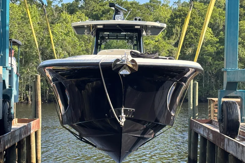  Yacht Photos Pics 2017 HCB Speciale boat being lifted at a dock with forest background.